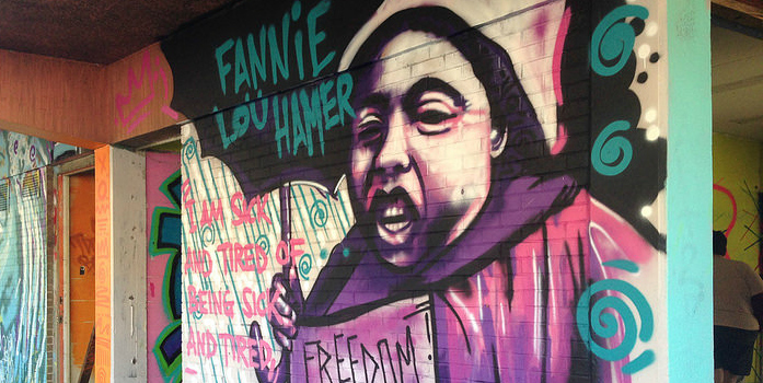 Colorful mural of civil rights leader Fannie Lou Hamer holding an umbrella, featuring the quote "I am sick and tired of being sick and tired"